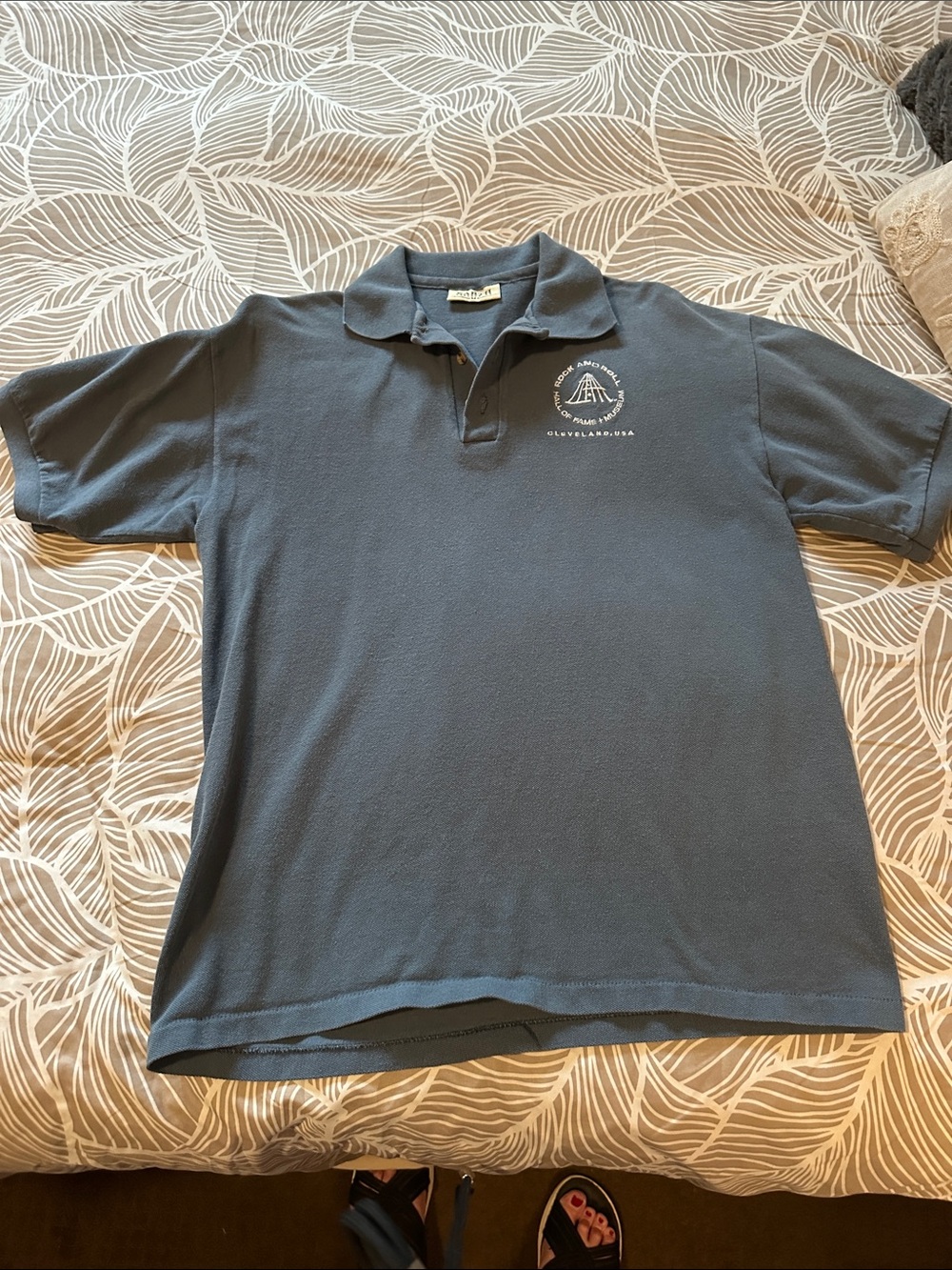 Men's blue Polo Shirt with Rock n Roll hall of fame emblem- earth
